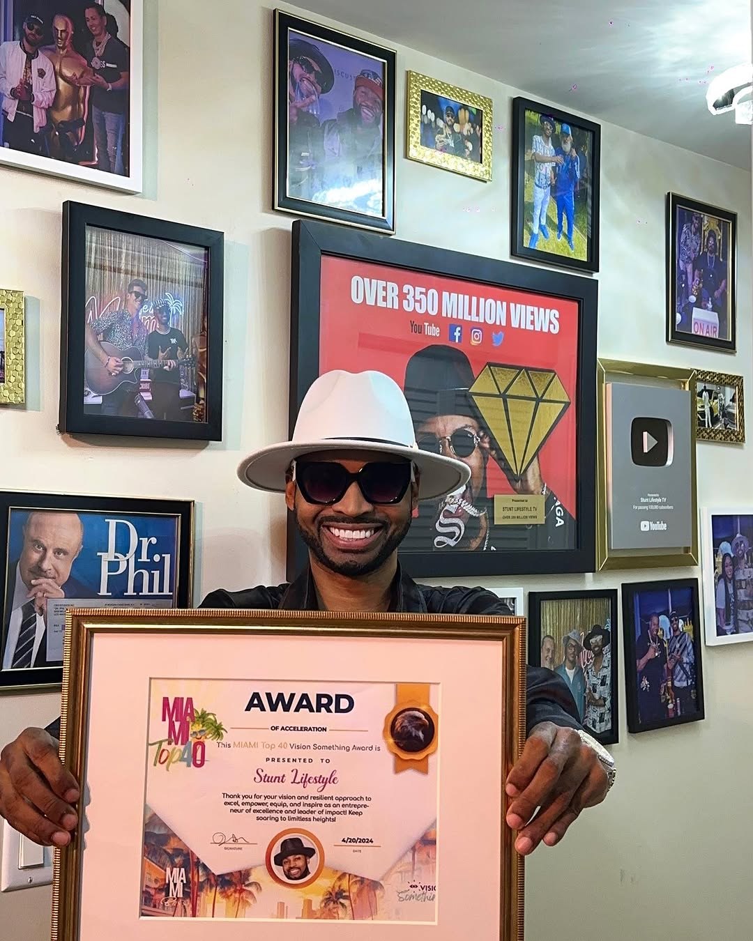 Stunt Lifestyle holding an award with YouTube plaque visible behind him